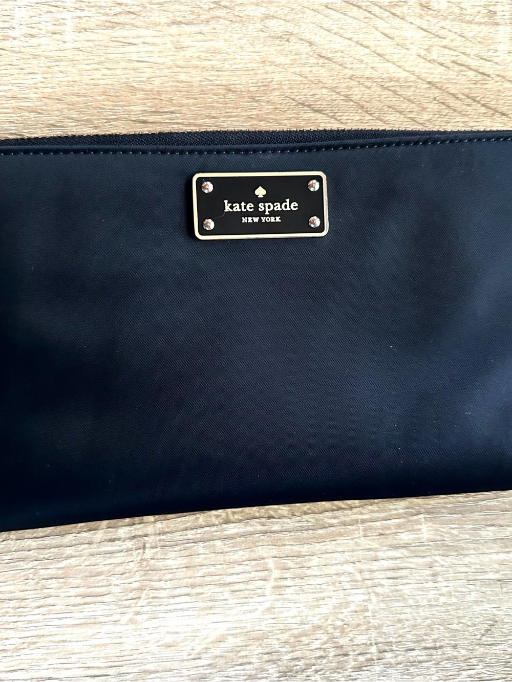 Kate Spade black wristlet clutch with gold plaque